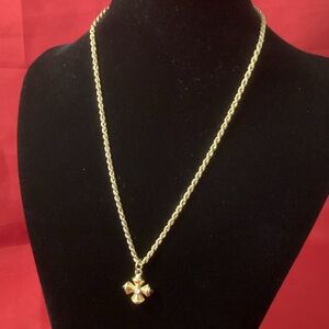 Gold tone and black cross pendant necklace